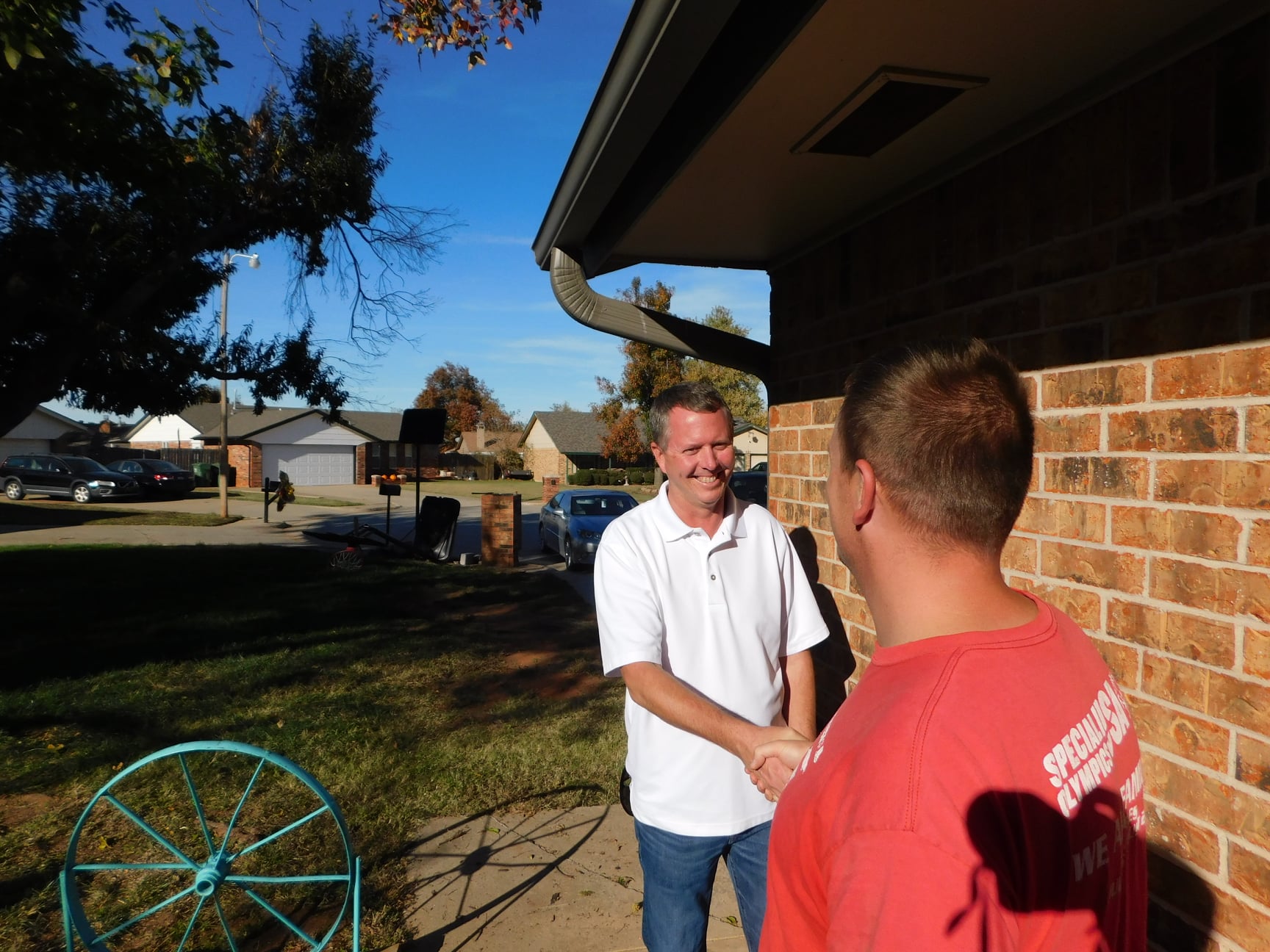 Rodney Zimmerman meeting with a constituent at their doorstep